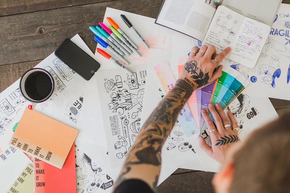 Colourful sketches, markers and swatches on a design desk